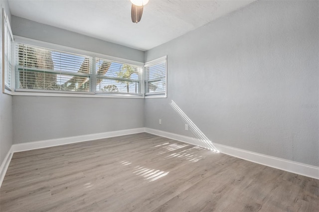 spare room featuring hardwood / wood-style floors and ceiling fan