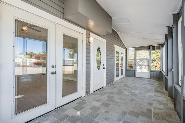 unfurnished sunroom featuring french doors and vaulted ceiling