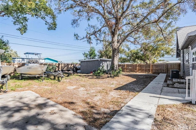 view of yard featuring cooling unit, a patio area, and an outdoor structure