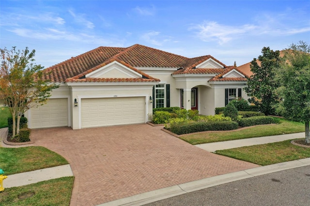 mediterranean / spanish-style house with a garage