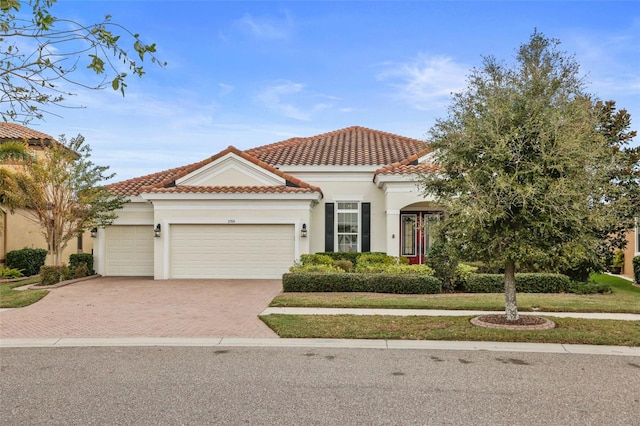 mediterranean / spanish-style home with a garage