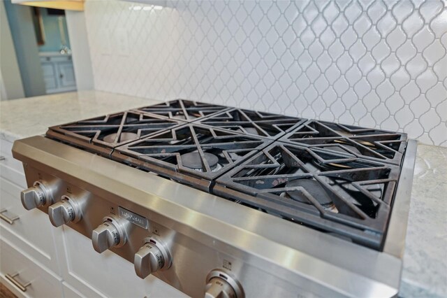 room details with stainless steel gas stovetop and stove