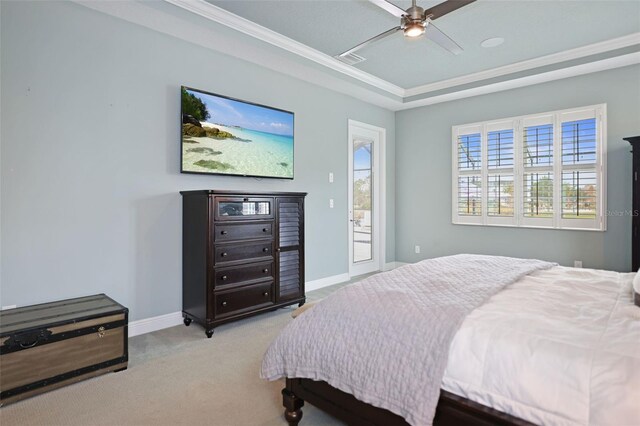 bedroom featuring light carpet, access to exterior, a raised ceiling, ornamental molding, and ceiling fan