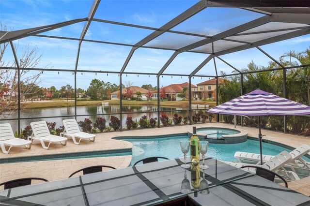 view of swimming pool featuring an in ground hot tub, a lanai, a water view, and a patio