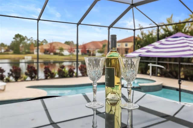 view of swimming pool with a lanai, a patio area, and an in ground hot tub