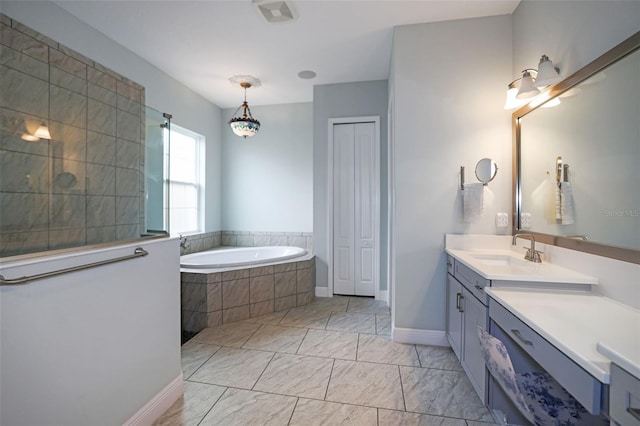 bathroom with vanity and tiled tub