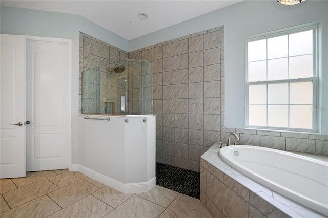 bathroom with a wealth of natural light and separate shower and tub