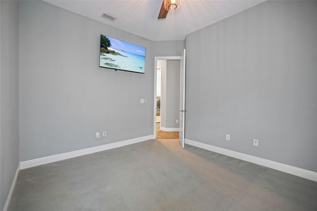 spare room featuring carpet floors and ceiling fan