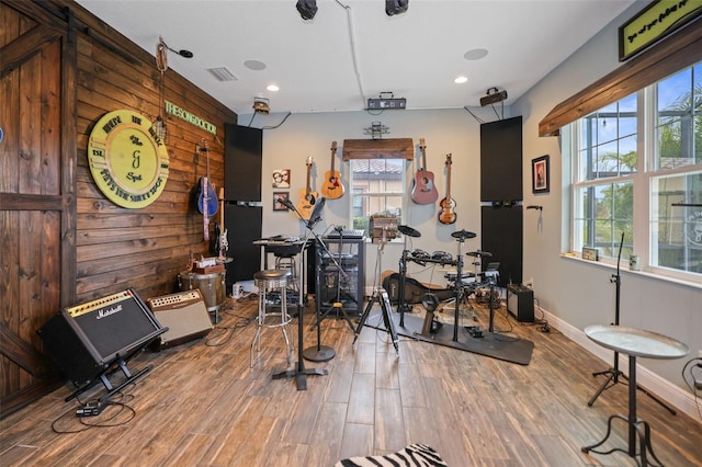 workout area featuring wooden walls and hardwood / wood-style floors