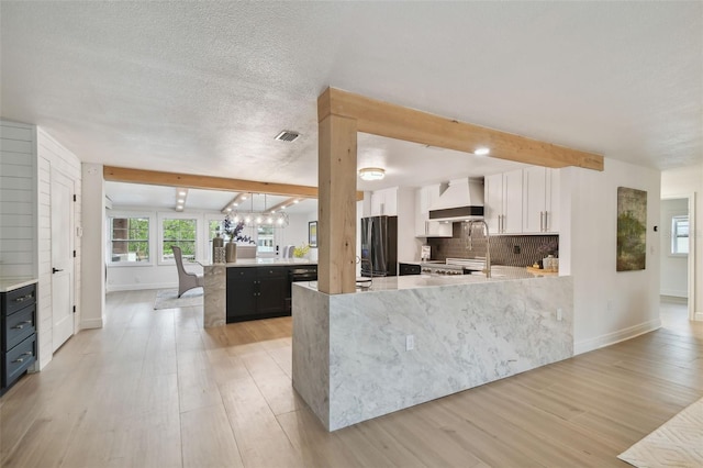 kitchen featuring white cabinets, custom exhaust hood, tasteful backsplash, stainless steel fridge, and beam ceiling