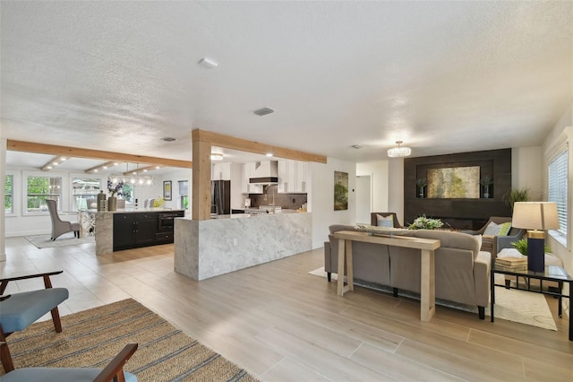 living room with light hardwood / wood-style floors and beamed ceiling