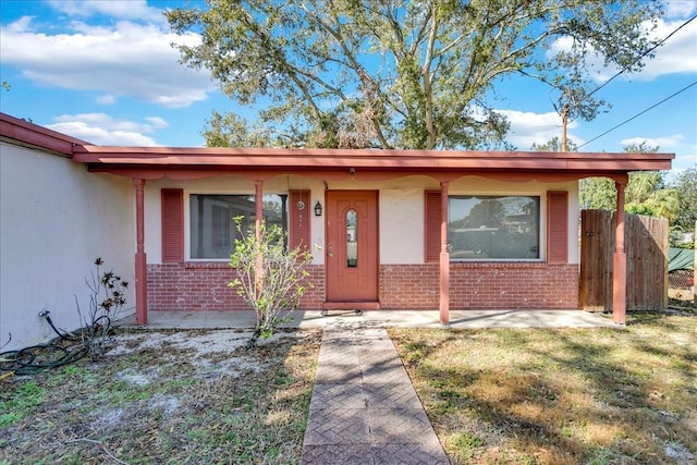 doorway to property featuring a yard