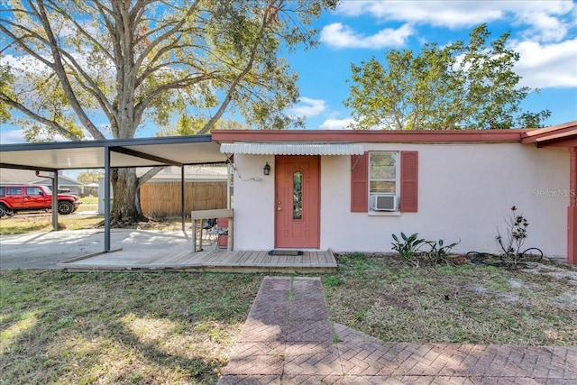 exterior space with cooling unit and a carport