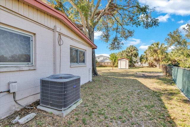 view of yard featuring central AC and a shed