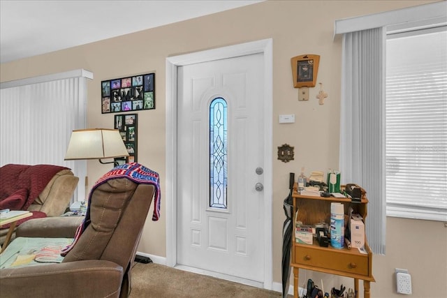 entrance foyer featuring plenty of natural light and carpet flooring