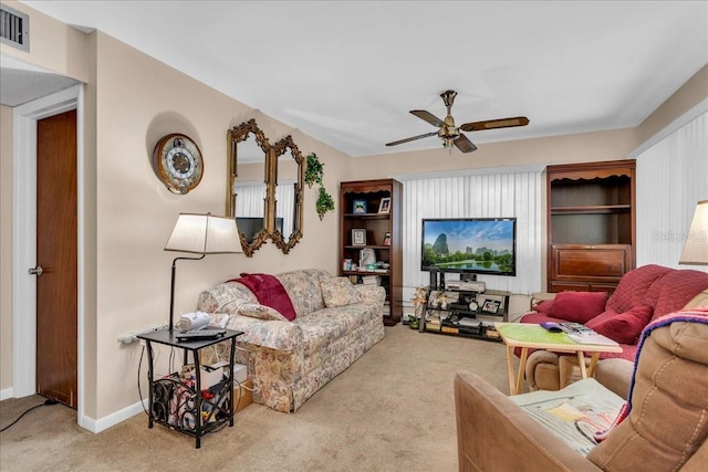 carpeted living room featuring ceiling fan