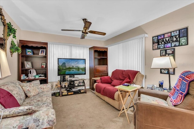 living room with ceiling fan and carpet