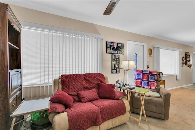 carpeted living room featuring ceiling fan