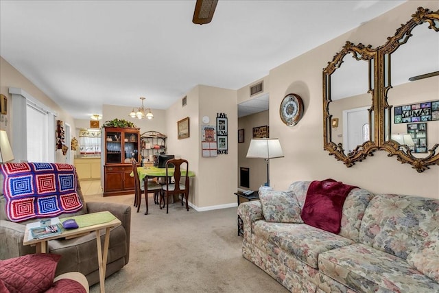 carpeted living room with a notable chandelier