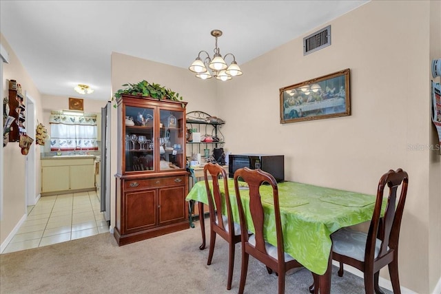 tiled dining space with a notable chandelier