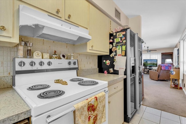 kitchen with white electric range oven, tasteful backsplash, stainless steel fridge, ceiling fan, and light tile patterned floors