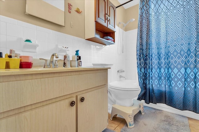 bathroom featuring toilet, tile walls, backsplash, and vanity