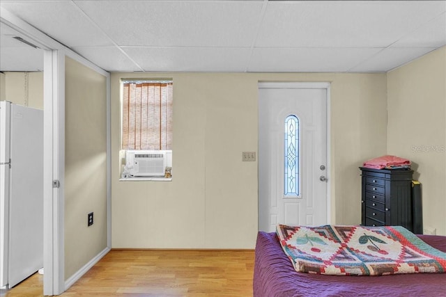 entrance foyer featuring a paneled ceiling, cooling unit, and hardwood / wood-style floors