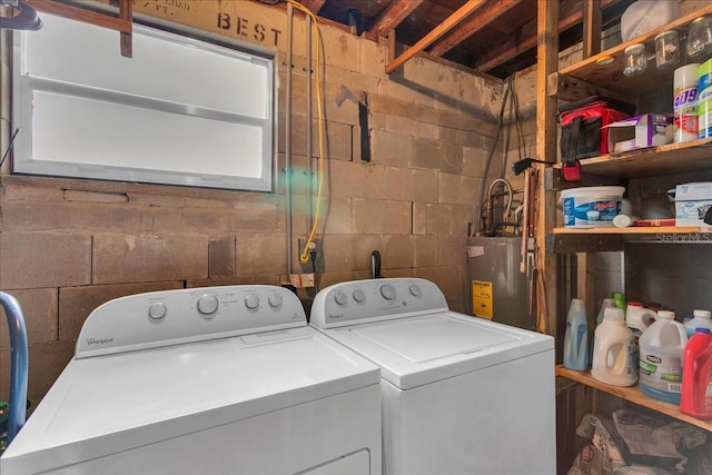 washroom featuring electric water heater and washer and dryer