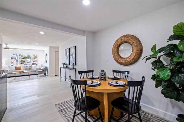 dining area featuring ceiling fan and light hardwood / wood-style flooring