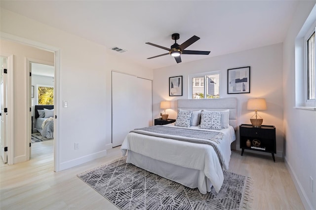 bedroom with ceiling fan and light hardwood / wood-style floors