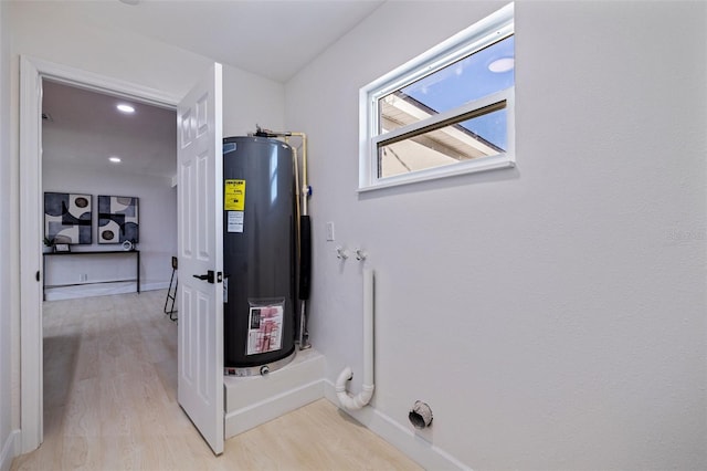 utility room featuring gas water heater