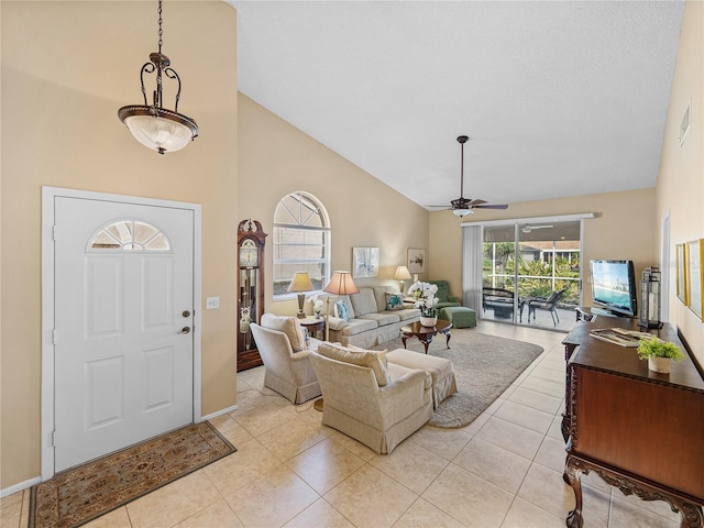 tiled living room featuring high vaulted ceiling and ceiling fan