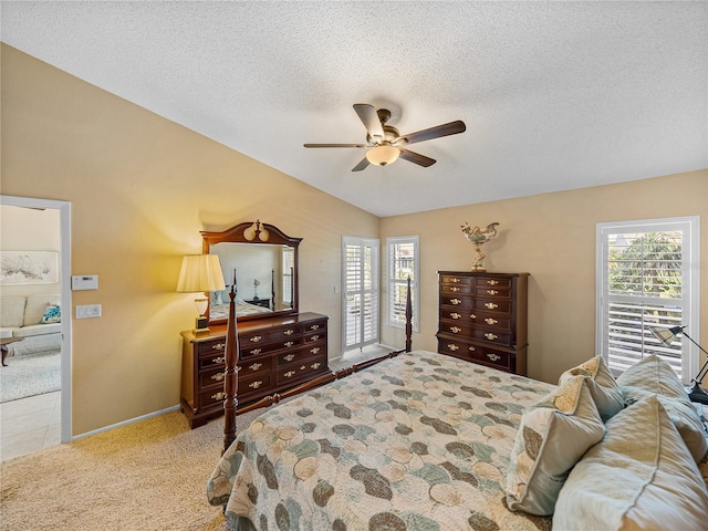 bedroom featuring light carpet, a textured ceiling, and ceiling fan