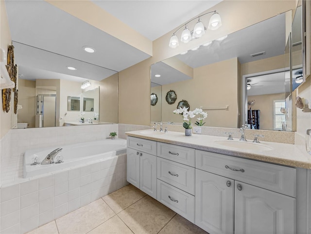 bathroom featuring tile patterned floors, ceiling fan, independent shower and bath, and vanity