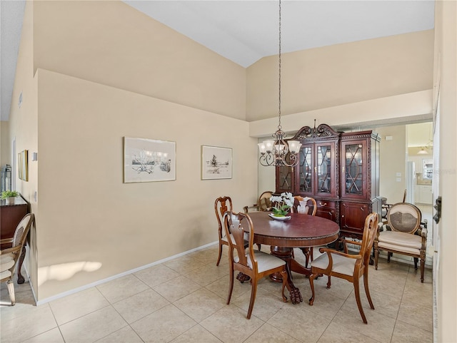 tiled dining space with a notable chandelier and lofted ceiling