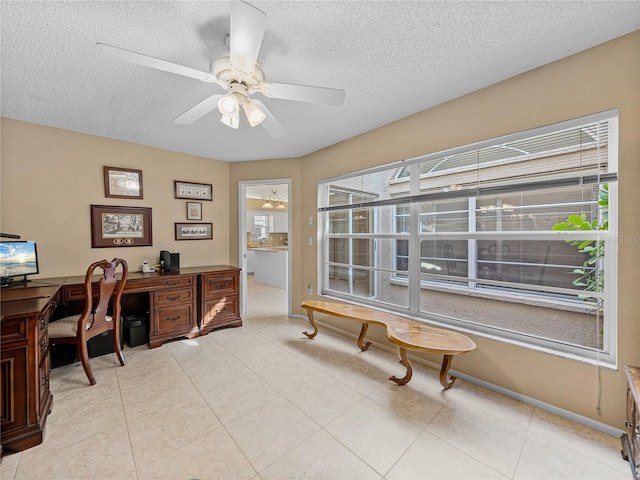 home office with ceiling fan and a textured ceiling