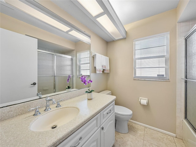 full bathroom featuring tile patterned floors, vanity, enclosed tub / shower combo, and toilet