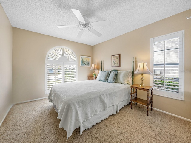 bedroom featuring multiple windows, light colored carpet, and ceiling fan