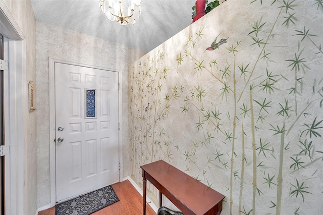 entryway with a chandelier and wood-type flooring