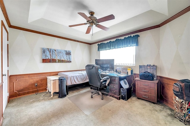 office space featuring light carpet, a tray ceiling, ceiling fan, and crown molding