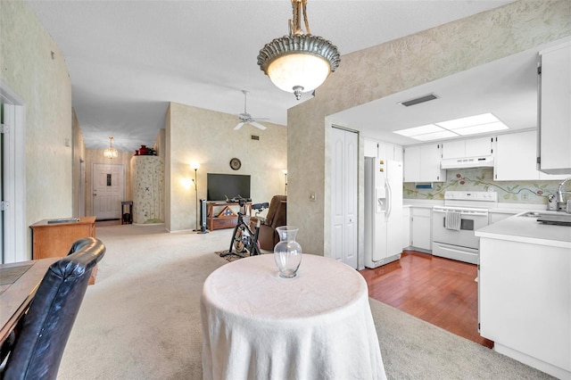 interior space with ceiling fan, sink, and dark wood-type flooring