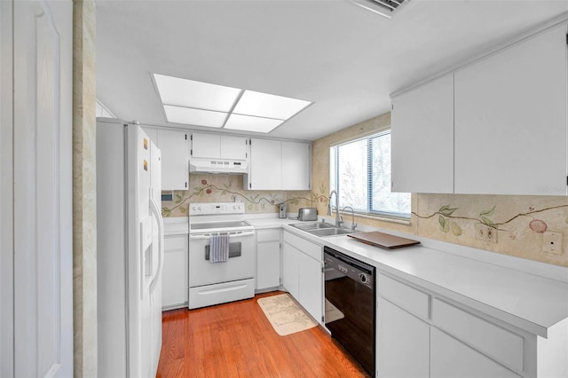 kitchen with white cabinetry, sink, light hardwood / wood-style flooring, white appliances, and decorative backsplash