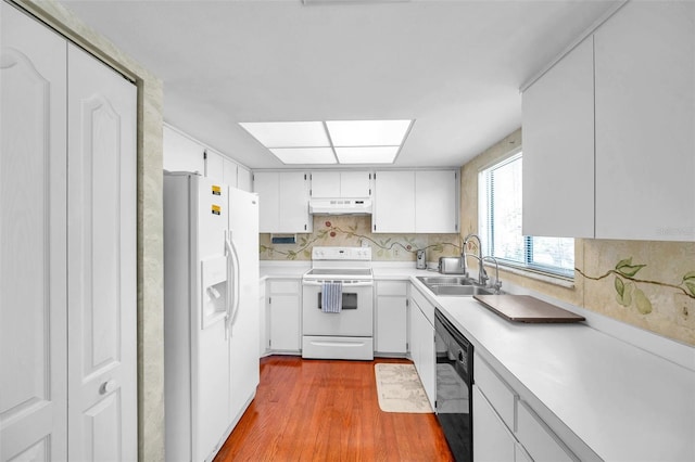 kitchen featuring dishwasher, white refrigerator with ice dispenser, white cabinets, sink, and electric range oven