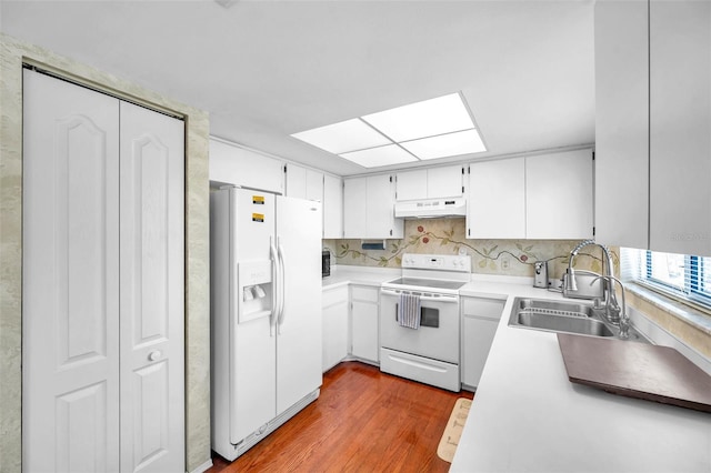 kitchen with hardwood / wood-style floors, custom exhaust hood, sink, white fridge with ice dispenser, and range