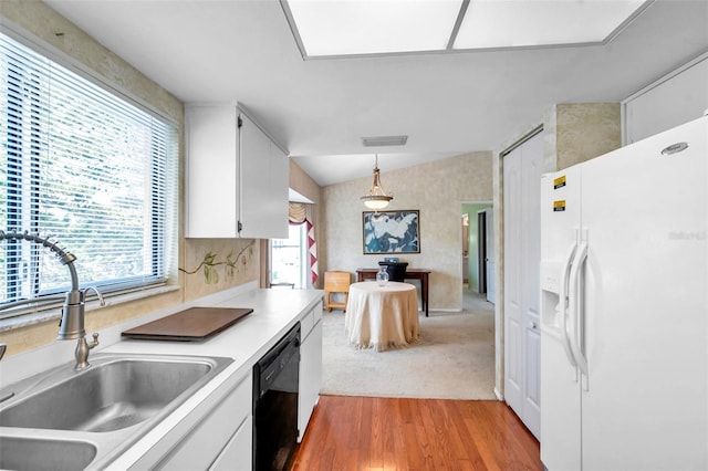 kitchen featuring dishwasher, white cabinets, sink, white fridge with ice dispenser, and decorative light fixtures