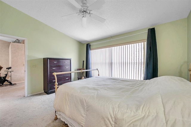 bedroom with a textured ceiling, ceiling fan, lofted ceiling, and light carpet