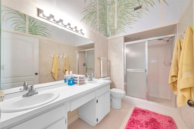 bathroom with a shower with door, vanity, tile patterned flooring, and toilet