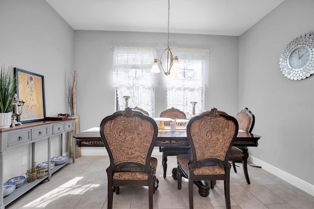 tiled dining space featuring an inviting chandelier