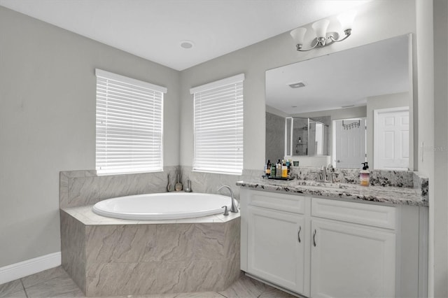 bathroom featuring vanity and plus walk in shower