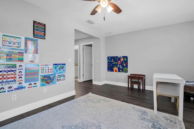 game room featuring dark wood-type flooring and ceiling fan